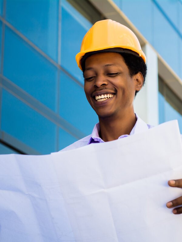 Portrait of Businessman engineer developer holding blueprint working outdoors.